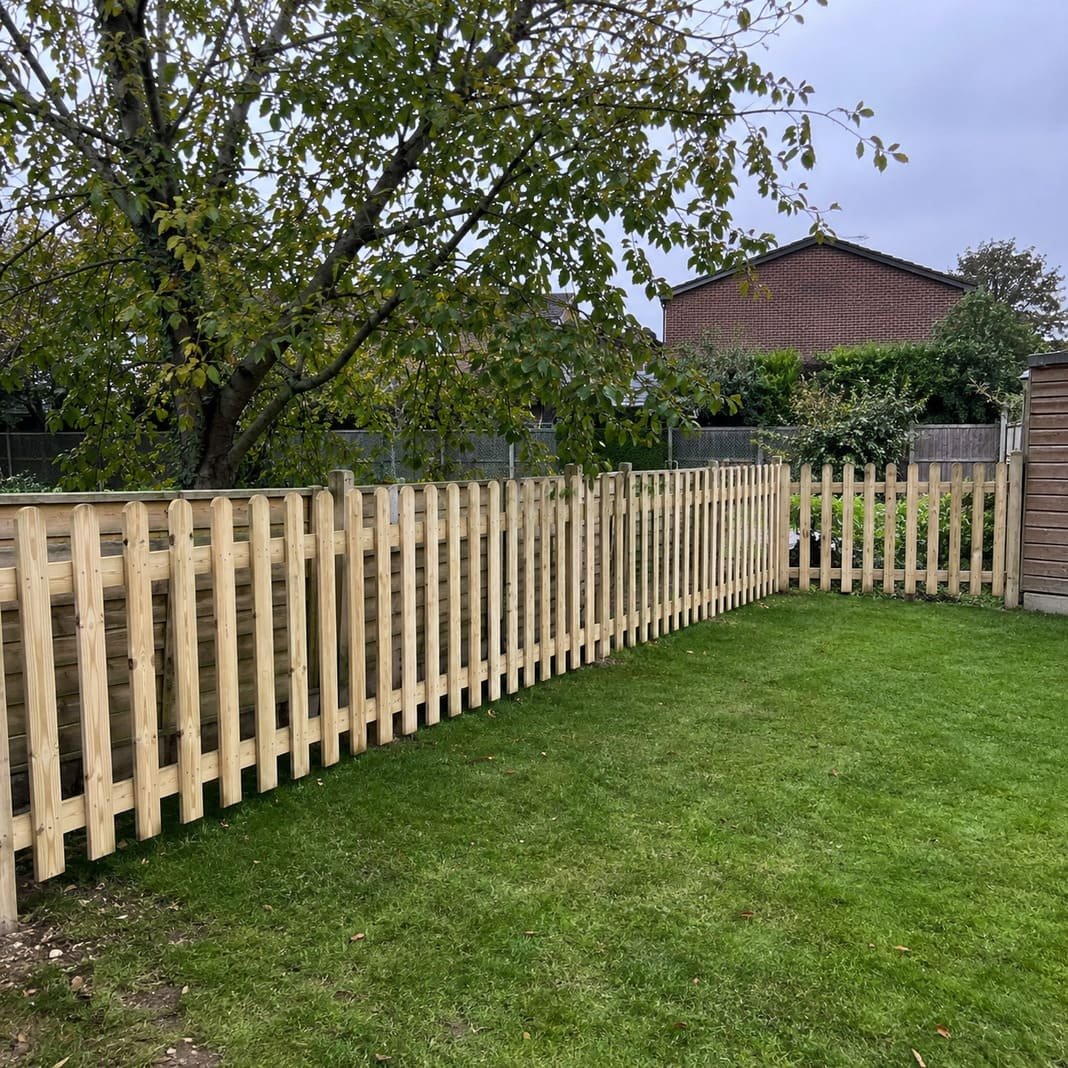 Low decorative picket fence in a front garden.