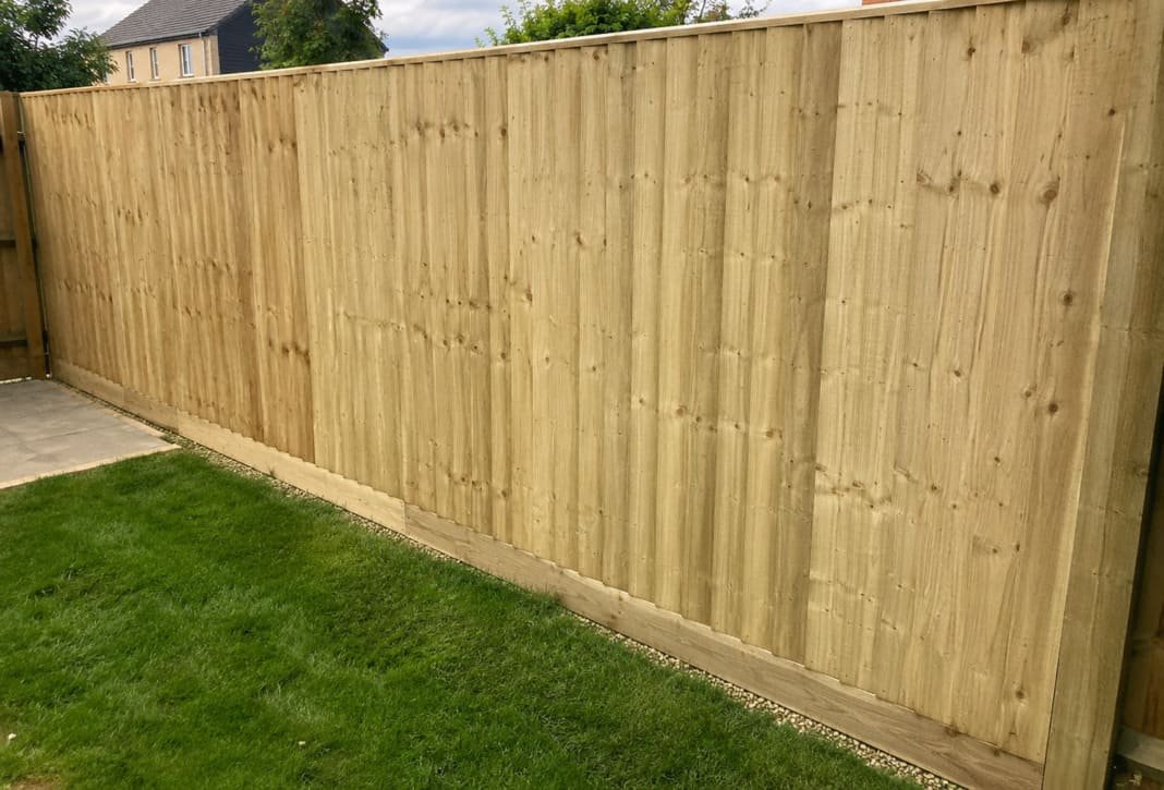 Close-board feather-edge garden fence with strong posts.